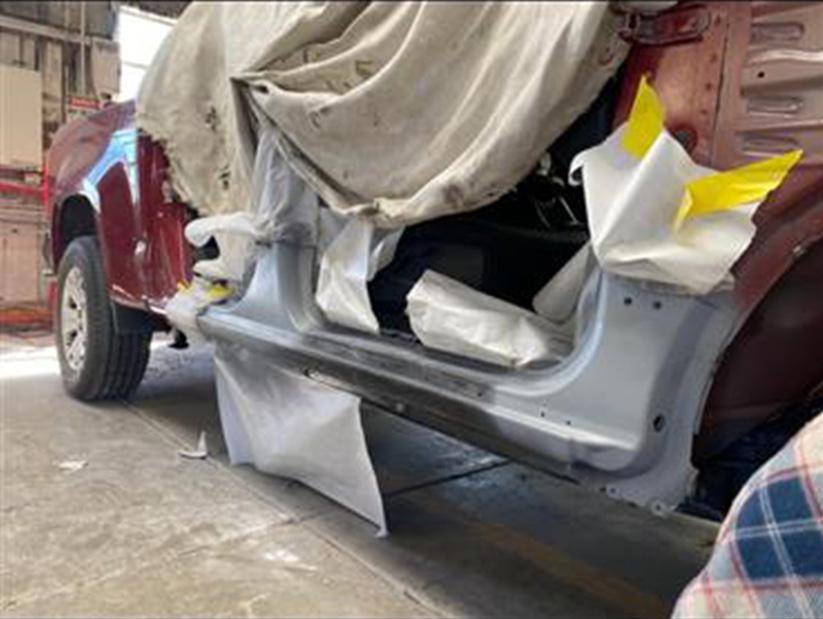 image of a car getting it's exterior fixed in a body shop